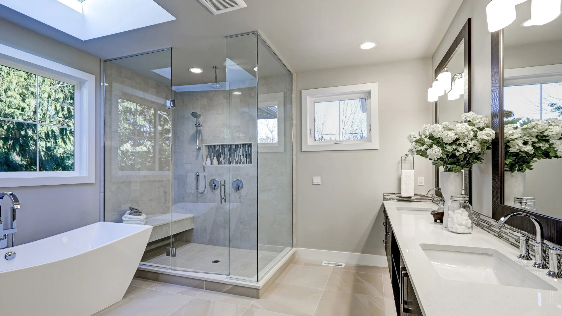 Modern bathroom remodel with glass walk-in shower, freestanding tub, and double vanity in Mesa, Arizona